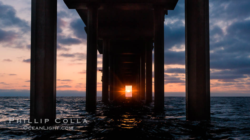 Scripps Pier solstice, surfer's view from among the waves, sunset aligned perfectly with the pier. Research pier at Scripps Institution of Oceanography SIO, sunset. La Jolla, California, USA, natural history stock photograph, photo id 30150