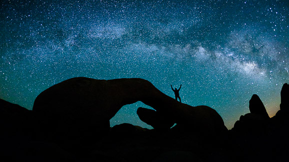 Self-portrait below the Milky Way in Joshua Tree National Park, California.