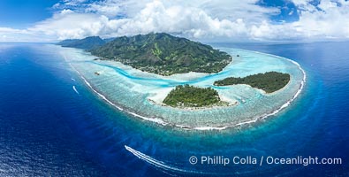 Barrier Reef around Moorea Island, French Polynesia. Motu Tiahura (left) and Motu Fareone (right) are the small islands in the foreground. The outer reef slope is seen adjacent to deep blue oceanic water with white waves breaking against the reef edge. Next, a wide shallow reef flat occurs dotted with coral bommies. Inside of that, a shallow protected lagoon is formed against the island.  Tall, rugged, eroded mountains are seen hinting at the age of the ancient volcano that originally formed the island and that is now sinking back down, leaving the encircling reef behind