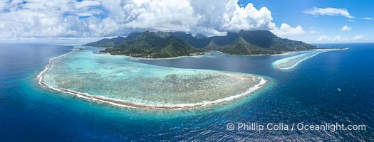 Barrier Reef around Moorea Island, French Polynesia. The outer reef slope is seen adjacent to deep blue oceanic water with white waves breaking against the reef edge. Next, a wide shallow reef flat occurs dotted with coral bommies. Inside of that, a shallow protected lagoon is formed against the island.  Tall, rugged, eroded mountains are seen hinting at the age of the ancient volcano that originally formed the island and that is now sinking back down, leaving the encircling reef behind