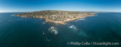 Aerial Panoramic Photo of Bird Rock and La Jolla Coast, with surfers in the waves.  Pacific Beach and Mission Beach are to the far right (south).  La Jolla's Mount Soledad rises in the center.  The submarine reefs around Bird Rock are visible through the clear water. This extremely high resolution panorama will print 80 inches high by 200 inches wide