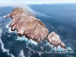 North Coronado Island, Mexico, southern point and keyhole looking north, clouds hugging the top of the island, San Diego in the distance, aerial photograph, Coronado Islands (Islas Coronado)