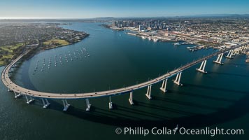 Aerial Photo of San Diego Coronado Bridge, known locally as the Coronado Bridge, links San Diego with Coronado, California. The bridge was completed in 1969 and was a toll bridge until 2002. It is 2.1 miles long and reaches a height of 200 feet above San Diego Bay. Coronado Island is to the left, and downtown San Diego is to the right in this view looking north