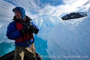 Photographer Patrick Endres works alongside an iceberg near Paulet Island