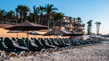 Beach chairs and umbrellas line the sand in front of resorts on Medano Beach, Cabo San Lucas, Mexico