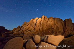 Boulders and stars, moonlight in Joshua Tree National Park. The moon gently lights unusual boulder formations at Jumbo Rocks in Joshua Tree National Park, California