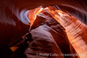 Canyon X, a spectacular slot canyon near Page, Arizona.  Slot canyons are formed when water and wind erode a cut through a (usually sandstone) mesa, producing a very narrow passage that may be as slim as a few feet and a hundred feet or more in height