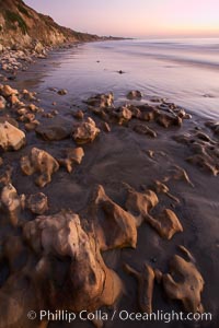 Rocks, sand, ocean and sea cliffs, sunset, Carlsbad, California