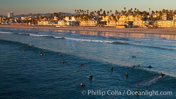The coast of Oceanside California, waves and surfers, beach houses, just before sunset, winter, looking north, Oceanside Pier