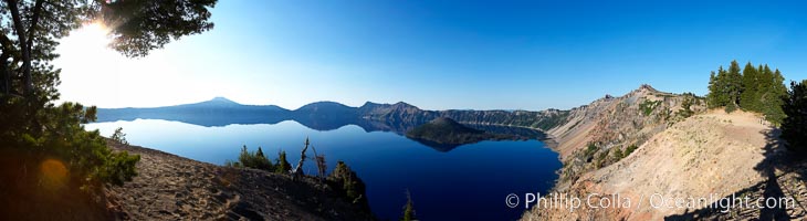 Panorama of Crater Lake at sunrise.  Crater Lake is the six-mile wide lake inside the collapsed caldera of volcanic Mount Mazama. Crater Lake is the deepest lake in the United States and the seventh-deepest in the world. Its maximum recorded depth is 1996 feet (608m). It lies at an altitude of 6178 feet (1880m), Crater Lake National Park