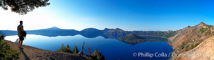 Self portrait at sunrise, panorama of Crater Lake.  Crater Lake is the six-mile wide lake inside the collapsed caldera of volcanic Mount Mazama. Crater Lake is the deepest lake in the United States and the seventh-deepest in the world. Its maximum recorded depth is 1996 feet (608m). It lies at an altitude of 6178 feet (1880m), Crater Lake National Park