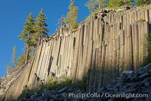 Devil's Postpile, a spectacular example of columnar basalt.  Once molten and under great pressure underground, the lava that makes up Devil's Postpile cooled evenly and slowly, contracting and fracturing into polygonal-sided columns.  The age of the formation is estimated between 100 and 700 thousand years old.  Sometime after the basalt columns formed, a glacier passed over the formation, cutting and polishing the tops of the columns.  The columns have from three to seven sides, varying because of differences in how quickly portions of the lava cooled, Devils Postpile National Monument, California