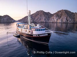 Dive boat Quino el Guardian anchored at  Isla Angel de la Guarda at Sunset, Aerial Photo, Sea of Cortez, Mexico.  Guardian Angel island is part of the Midriff Islands in Mexico's Sea of Cortez