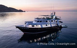 Dive boat Rocio del Mar anchored at  Isla Angel de la Guarda at Sunset, Aerial Photo, Sea of Cortez, Mexico.  Guardian Angel island is part of the Midriff Islands in Mexico's Sea of Cortez