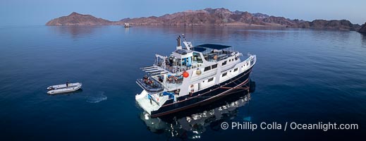 Dive boat Rocio del Mar anchored at  Isla Angel de la Guarda at Sunset, Aerial Photo, Sea of Cortez, Mexico.  Guardian Angel island is part of the Midriff Islands in Mexico's Sea of Cortez