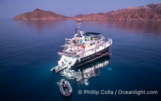 Dive boat Rocio del Mar anchored at  Isla Angel de la Guarda at Sunset, Aerial Photo, Sea of Cortez, Mexico.  Guardian Angel island is part of the Midriff Islands in Mexico's Sea of Cortez