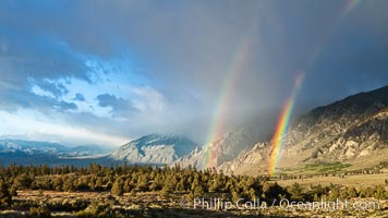 Double rainbow forms in storm clouds, over Swall Meadows and Round Valley in the Eastern Sierra Nevada, Bishop, California