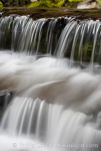 Fern Springs, a small natural spring in Yosemite Valley near the Pohono Bridge, trickles quietly over rocks as it flows into the Merced River. Yosemite Valley, Yosemite National Park, California