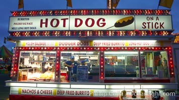 Food vendors at the Del Mar Fair, famous for their tasty, greasy, salty, fattening and generally unwholesome food, which visitors eat by the ton.  Bright lights at night