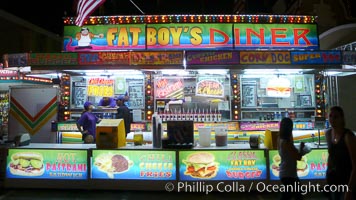 Food vendors at the Del Mar Fair, famous for their tasty, greasy, salty, fattening and generally unwholesome food, which visitors eat by the ton.  Bright lights at night