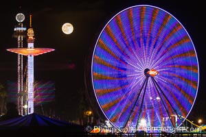 Full moon rising at night over the San Diego County Fair.  Del Mar Fair at night