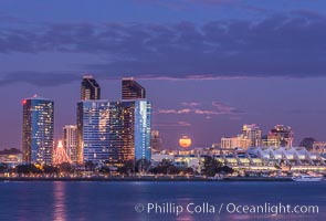 Full moon rising over San Diego city skyline, sunset, storm clouds, viewed from Coronado Island