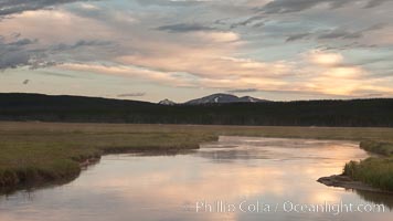 Gibbon River meanders through Gibbon Meadows, sunrise and clouds reflected in the calm waters, Yellowstone National Park, Wyoming