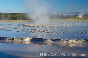 Great Fountains large vent (16 feet across) sits amid wide sinter terraces that act as reflecting pools as the geyser slows fills prior to its eruption.  Firehole Lake Drive, Lower Geyser Basin, Yellowstone National Park, Wyoming