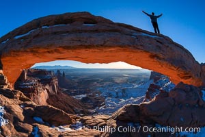 Extended High Mountain pose, Utthita Tadasana, sunrise on Mesa Arch, Utah.  An exuberant hiker greets the dawning sun from atop Mesa Arch, Island in the Sky, Canyonlands National Park