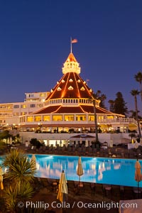 Hotel del Coronado with holiday Christmas night lights, known affectionately as the Hotel Del. It was once the largest hotel in the world, and is one of the few remaining wooden Victorian beach resorts. It sits on the beach on Coronado Island, seen here with downtown San Diego in the distance. It is widely considered to be one of Americas most beautiful and classic hotels. Built in 1888, it was designated a National Historic Landmark in 1977