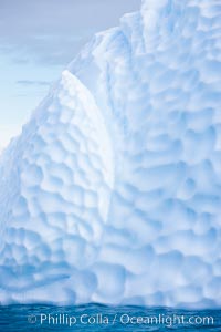 Iceberg with scalloped erosion.  The eroded indentations on this iceberg were melted when this portion of the iceberg was underwater.  As it melted, the iceberg grew topheavy, eventually flipping and exposing this interesting surface, Paulet Island