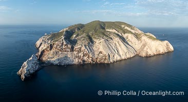 Isla San Pedro Martir aerial photo, Sea of Cortez, Mexico. San Pedro Martir Island and its marine life are, since 2002, part of the San Pedro Martir Biosphere Reserve, and is regarded as a natural laboratory of adaptive evolution, similar to that of the Galapagos Islands. It is home to 292 species of fauna and flora (both land-based and aquatic), with 42 species protected by Mexican law, and 30 listed on the Red List of Threatened Species. San Pedro Martir is also unique in the area for its year-round quantity of birds. The island is the only island in the area with a perpetually swirling cloud of sea birds. This is because the water around the island, has some of the most successful marine productivity in the world