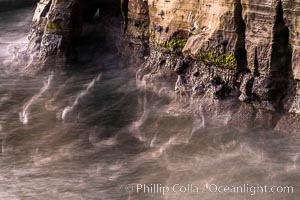 Sea Caves, the famous La Jolla sea caves lie below tall cliffs at Goldfish Point.  Sunny Jim Cave. Sunrise. Sea gulls floating int he water blur in this time exposure