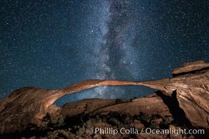 Landscape Arch and Milky Way galaxy.  Stars rise over Landscape arch at night, filling the Utah sky, while the arch is gently lit by a hiker's light. (Note: this image was created before a ban on light-painting in Arches National Park was put into effect.  Light-painting is no longer permitted in Arches National Park)