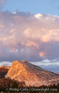 Lembert Dome and late afternoon clouds rise above Tuolumne Meadows in the High Sierra, catching the fading light of sunset, Yosemite National Park, California