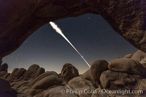 Lunar Eclipse Sequence, the path of the moon through the sky as it progresses from being fully visible (top) to fully eclipsed (middle) to almost fully visible again (bottom), viewed through Arch Rock, April 4 2015, Joshua Tree National Park, California