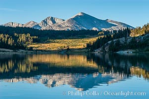 Mammoth Peak in the High Sierra range is reflected in Tioga Lake at sunrise. This spectacular location is just a short walk from the Tioga Pass road. Near Tuolumne Meadows and Yosemite National Park