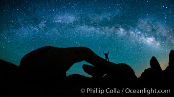 The Milky Way galaxy arches over Arch Rock on a clear evening in Joshua Tree National Park