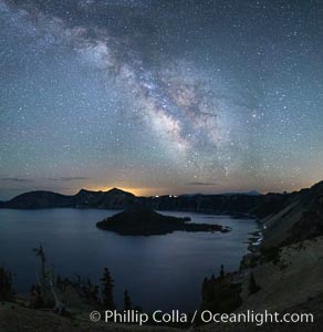 Milky Way and stars over Crater Lake at night. Panorama of Crater Lake and Wizard Island at night, Crater Lake National Park