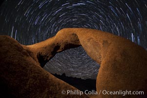 Mobius Arch in the Alabama Hills, seen here at night with swirling star trails formed in the sky above due to a long time exposure, Alabama Hills Recreational Area