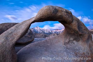 Mobius Arch at sunrise, framing snow dusted Lone Pine Peak and the Sierra Nevada Range in the background. Also known as Galen's Arch, Mobius Arch is found in the Alabama Hills Recreational Area near Lone Pine