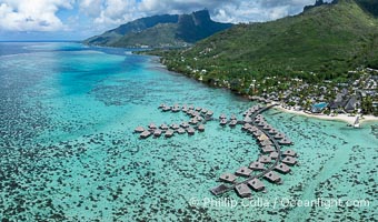 Moorea rises above its lagoon and barrier reef, French Polynesia, aerial view. Cooks Bay lies in the distance