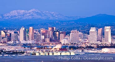 Dusk settles on downtown San Diego with snow-covered Mount Laguna in the distance