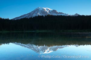 Mount Rainier is reflected in the calm waters of Reflection Lake, early morning, Mount Rainier National Park, Washington