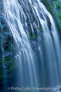 Narada Falls cascades down a cliff, with the flow blurred by a time exposure.  Narada Falls is a 188 foot (57m) waterfall in Mount Rainier National Park