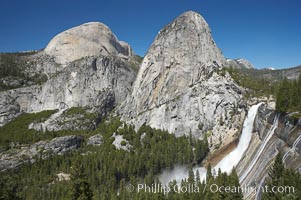 Nevada Falls, with Liberty Cap (center) and Half Dome (left). Nevada Falls marks where the Merced River plummets almost 600 feet through a joint in the Little Yosemite Valley, shooting out from a sheer granite cliff and then down to a boulder pile far below, Yosemite National Park, California