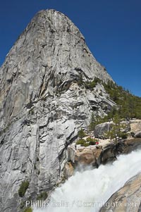 Nevada Falls, with Liberty Cap rising above it. Nevada Falls marks where the Merced River plummets almost 600 through a joint in the Little Yosemite Valley, shooting out from a sheer granite cliff and then down to a boulder pile far below, Yosemite National Park, California