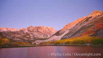 North Lake lit by alpenglow before sunrise, a three frame panorama, with groves of yellow and orange aspen trees on the side of Paiute Peak, Bishop Creek Canyon, Sierra Nevada Mountains