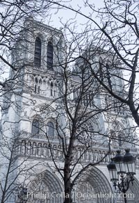 Notre Dame Cathedral, trees and streetlamp, west facade, Paris. Notre Dame de Paris ("Our Lady of Paris"), also known as Notre Dame Cathedral or simply Notre Dame, is a historic Roman Catholic Marian cathedral on the eastern half of the Ile de la Cite in the fourth arrondissement of Paris, France. Widely considered one of the finest examples of French Gothic architecture and among the largest and most well-known churches in the world ever built, Notre Dame is the cathedral of the Catholic Archdiocese of Paris