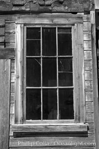Battered old window and frame on whats left of a small private home